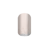 A nail wrap with a nude colour and glittery design at the tip.